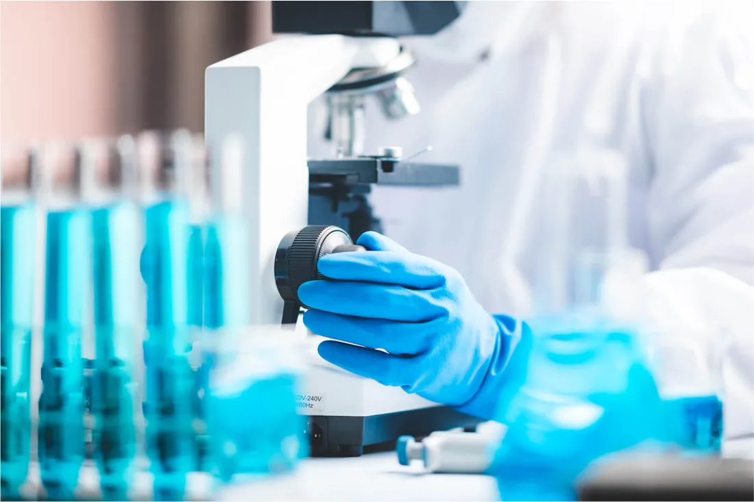 Illustrative laboratory image with samples and a microscope